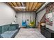 Unfinished basement playroom featuring a comfortable lounge area and creative play space at 3607 Anna Nw Ln, Kennesaw, GA 30144