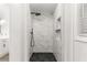 Modern bathroom features a glass-enclosed shower with marble tile and dark stone flooring at 3607 Anna Nw Ln, Kennesaw, GA 30144