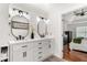 Elegant bathroom with double sinks, white vanities, shiplap walls, and modern fixtures at 3607 Anna Nw Ln, Kennesaw, GA 30144