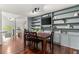 Open dining area showcases dark wood table, chairs and custom shelving with cabinets, and decorative elements at 3607 Anna Nw Ln, Kennesaw, GA 30144