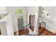 Bright foyer features hardwood floors, a staircase with iron railing, and a view of the front door and arched window above at 3607 Anna Nw Ln, Kennesaw, GA 30144