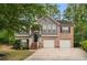 Charming two-story home with brick and gray siding, attached two-car garage, landscaped lawn and mature shade trees at 3607 Anna Nw Ln, Kennesaw, GA 30144
