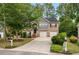 Charming two-story home with brick and gray siding, attached two-car garage, and well-manicured lawn with mature shade trees at 3607 Anna Nw Ln, Kennesaw, GA 30144