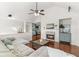 Bright living room features vaulted ceilings, hardwood floors, comfortable gray sectional sofa, and stone fireplace with hearth at 3607 Anna Nw Ln, Kennesaw, GA 30144