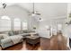 Bright living room features vaulted ceilings, hardwood floors, a comfortable gray sectional sofa, and a gas fireplace at 3607 Anna Nw Ln, Kennesaw, GA 30144