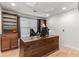 Home office features a rustic wooden desk, built-in shelving, and a comfortable workspace with natural light at 3607 Anna Nw Ln, Kennesaw, GA 30144