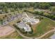 Aerial view showcases a skate park with ramps, bowls, and recreational elements surrounded by lush greenery and parking at 3607 Anna Nw Ln, Kennesaw, GA 30144