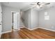 A bedroom showcasing hardwood floors, a ceiling fan, and staircase access at 4103 Mars Bay # 25, Acworth, GA 30101