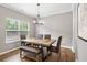 Dining room featuring rustic wood table and modern chandelier at 4103 Mars Bay # 25, Acworth, GA 30101