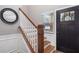 Welcoming foyer with wood stairs, round mirror and modern black door with glass insert at 4103 Mars Bay # 25, Acworth, GA 30101
