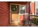 A cozy front porch featuring a wooden rocking chair and seasonal wreath on the front door at 4103 Mars Bay # 25, Acworth, GA 30101