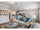 Spacious living room with neutral tones and hardwood floors, open to the dining area at 4103 Mars Bay # 25, Acworth, GA 30101