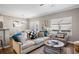 Comfortable living room featuring a plush sofa, accent pillows, and natural light at 4103 Mars Bay # 25, Acworth, GA 30101