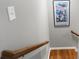 A close-up of a staircase with a wooden handrail and framed art on the wall at 4103 Mars Bay # 25, Acworth, GA 30101