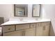 Bright bathroom featuring a dual sink vanity with white countertop and decorative framed mirrors at 109 Red Fox Dr, Dallas, GA 30157