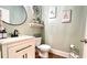 Cozy half bathroom with updated fixtures, decorative mirror and a decorative shelf for storage at 109 Red Fox Dr, Dallas, GA 30157