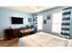 Blue bedroom featuring a bed, foosball table, desk, and game-themed decor at 109 Red Fox Dr, Dallas, GA 30157