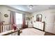 Charming Bedroom featuring stylish decor, including a crib and comfortable chair at 109 Red Fox Dr, Dallas, GA 30157