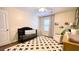 Bedroom with green accent wall, crib, accent chair, and natural wood dresser at 109 Red Fox Dr, Dallas, GA 30157