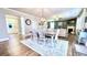 Open concept dining room with decorative rug, modern lighting, and an open view to the front entry and living room at 109 Red Fox Dr, Dallas, GA 30157
