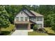 Charming two-story home with stone accents and meticulously manicured landscaping at 109 Red Fox Dr, Dallas, GA 30157