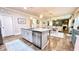 Open kitchen with island, stainless steel dishwasher, granite counters, and views of the dining and living room at 109 Red Fox Dr, Dallas, GA 30157