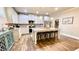 Spacious kitchen features island seating, stainless steel appliances, white cabinetry, and hardwood floors at 109 Red Fox Dr, Dallas, GA 30157