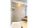 Shower stall featuring a tile surround, built-in bench, and adjustable shower head at 109 Red Fox Dr, Dallas, GA 30157
