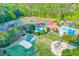 An aerial view shows the community amenities, including tennis and basketball courts, swimming pool, clubhouse, and playground at 1336 Amberwood Dr, Woodstock, GA 30189