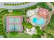 Aerial view of community amenities featuring tennis courts, a swimming pool, and a playground, surrounded by trees at 1336 Amberwood Dr, Woodstock, GA 30189