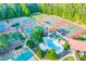 An aerial view of the community's amenities, including multiple tennis courts and a sparkling swimming pool surrounded by lush greenery at 1336 Amberwood Dr, Woodstock, GA 30189