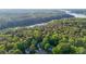 Overhead shot showing the house nestled amongst trees and near the lake and forested area in a beautiful residential setting at 1336 Amberwood Dr, Woodstock, GA 30189