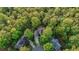 An aerial view of the house surrounded by green trees in a quiet neighborhood at 1336 Amberwood Dr, Woodstock, GA 30189