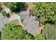 Aerial view showcasing the home's roof, driveway, and surrounding mature trees providing ample privacy at 1336 Amberwood Dr, Woodstock, GA 30189