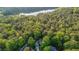 Gorgeous aerial view of wooded lot, lake, and homes with mature trees and natural beauty at 1336 Amberwood Dr, Woodstock, GA 30189