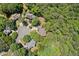 Panoramic aerial view of homes nestled in a lush, green, wooded neighborhood with mature trees and manicured lawns at 1336 Amberwood Dr, Woodstock, GA 30189