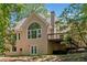 A backyard with a wooden deck, well maintained lawn, and unique architectural features at 1336 Amberwood Dr, Woodstock, GA 30189