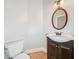 Bathroom featuring a sleek vanity, wood floors, and a stylish mirror at 1336 Amberwood Dr, Woodstock, GA 30189