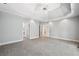 Large bedroom featuring a trey ceiling, neutral carpet, and multiple doorways to other rooms at 1336 Amberwood Dr, Woodstock, GA 30189