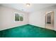 Bedroom with green carpet and light walls, features a window with natural light at 1336 Amberwood Dr, Woodstock, GA 30189