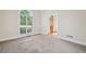 Bright bedroom features neutral carpet, light walls and a window with half-round transom at 1336 Amberwood Dr, Woodstock, GA 30189