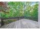 Wood deck offers a relaxing outdoor space with a beautiful backdrop of lush green trees at 1336 Amberwood Dr, Woodstock, GA 30189