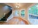Light-filled dining area with hardwood floors, staircase, and views of the backyard at 1336 Amberwood Dr, Woodstock, GA 30189