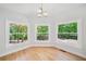 Hardwood floor dining area with three large windows overlooking wooded backyard at 1336 Amberwood Dr, Woodstock, GA 30189