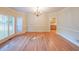 Elegant dining room with hardwood floors, chandelier, and bright window with shuttered doors at 1336 Amberwood Dr, Woodstock, GA 30189