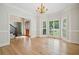 Bright dining room featuring hardwood floors, large windows, and access to the foyer at 1336 Amberwood Dr, Woodstock, GA 30189