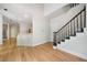 Bright entryway with hardwood floors and a staircase with white risers and green carpet at 1336 Amberwood Dr, Woodstock, GA 30189