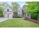 Beautiful home with manicured lawn, two-car garage, and a welcoming front entrance at 1336 Amberwood Dr, Woodstock, GA 30189