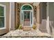 Inviting entryway with stone accents, potted plants, and a decorative welcome mat for added curb appeal at 1336 Amberwood Dr, Woodstock, GA 30189