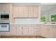 Bright kitchen featuring white cabinets, white countertops and stainless steel appliances at 1336 Amberwood Dr, Woodstock, GA 30189